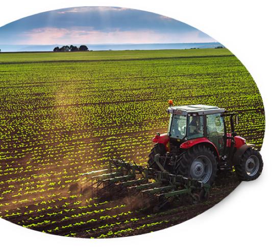 A tractor that farm 和 牧场 pp王者电子官网 covers tills the soil as the sun breaks through the clouds.